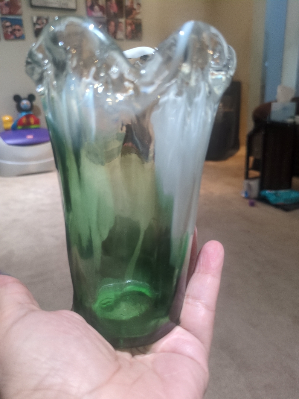 Hand-blown art glass vase with green and white swirls and a ruffled rim 6"